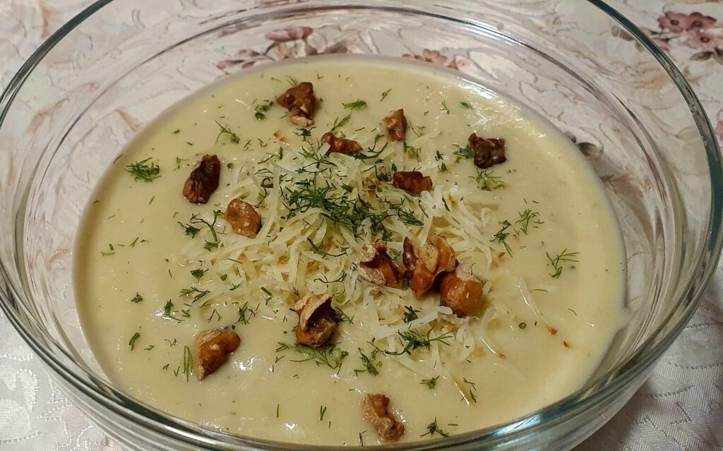 Experience the velvety texture and rich aroma of Nutty Celery Cream Soup by Klara. Featuring tender celery, fennel, and potato, infused with hints of ginger and saffron. Topped with roasted walnuts and smoked cheese, each spoonful offers a delightful crunch. Dive into a bowlful of comfort!